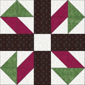 May include: A quilt block with a geometric pattern featuring green, white, and burgundy fabric. The block is made up of triangles and squares.