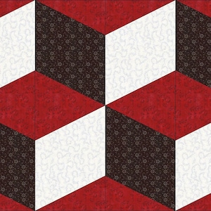 Może przedstawiać: Blok patchworku z geometrycznym wzorem, z naprzemiennymi kwadratami w kolorze czerwonym, białym i czarnym. Kwadraty są ułożone w trójwymiarowy wzór, tworząc iluzję sześcianów.