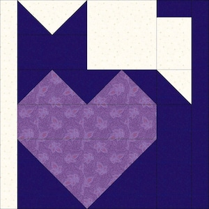 May include: A purple and white patchwork quilt block with a heart shape in the centre. The heart is made of purple fabric with a floral pattern. The block is surrounded by a dark blue border.