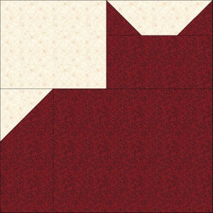 May include: A patchwork quilt block featuring a cream-colored square and triangles, contrasted with a deep red fabric patterned with a dark floral design. The block is composed of several geometric shapes, creating a visually interesting pattern.