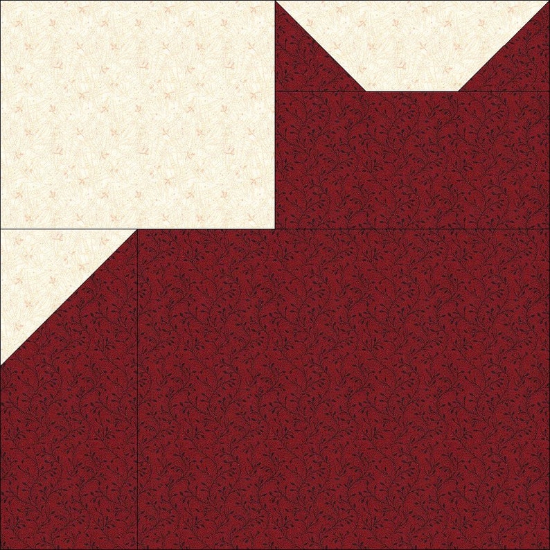 May include: A patchwork quilt block featuring a cream-colored square and triangles, contrasted with a deep red fabric patterned with a dark floral design. The block is composed of several geometric shapes, creating a visually interesting pattern.