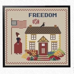 Op de afbeelding: Borduurpatroon met een huis met een rode deur, een vogel op het dak en een vrouw die naast een Amerikaanse vlag staat. De tekst "FREEDOM USA" is geborduurd boven het huis.