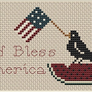May include: Cross-stitch embroidery design featuring a black bird holding a small American flag in its beak, perched on a red watermelon slice. The text "God Bless America" is stitched in red below the bird.