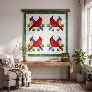 May include: A quilted wall hanging featuring four cardinal bird designs. Each bird is red with yellow and blue accents, set against a white background with green borders. The artwork is displayed on a wooden rod.