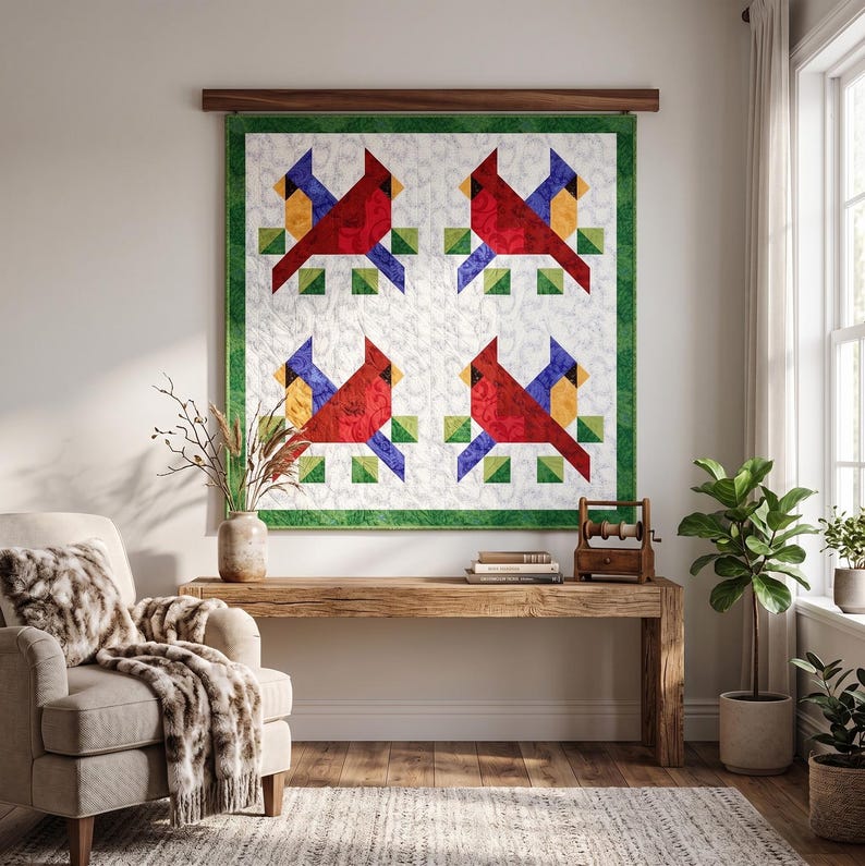 May include: A quilted wall hanging featuring four cardinal bird designs. Each bird is red with yellow and blue accents, set against a white background with green borders. The artwork is displayed on a wooden rod.