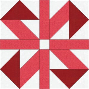Pode incluir: Um design de bloco de colcha geométrico com tecido vermelho e branco. O design inclui triângulos, retângulos e formas angulares dispostas simetricamente. O tecido vermelho tem um padrão texturizado sutil.