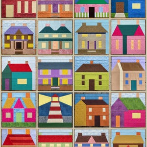 May include: A collection of twenty fabric quilt blocks arranged in a grid, each featuring a unique house or building design constructed from various solid and patterned cotton fabrics in a wide array of vibrant colors including red, blue, green, and yellow.