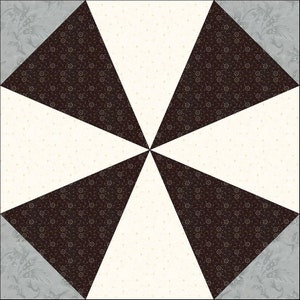 May include: A quilt block with a geometric design featuring four black triangles with a white floral pattern, four white triangles with a small black dot pattern, and four gray triangles with a floral pattern.