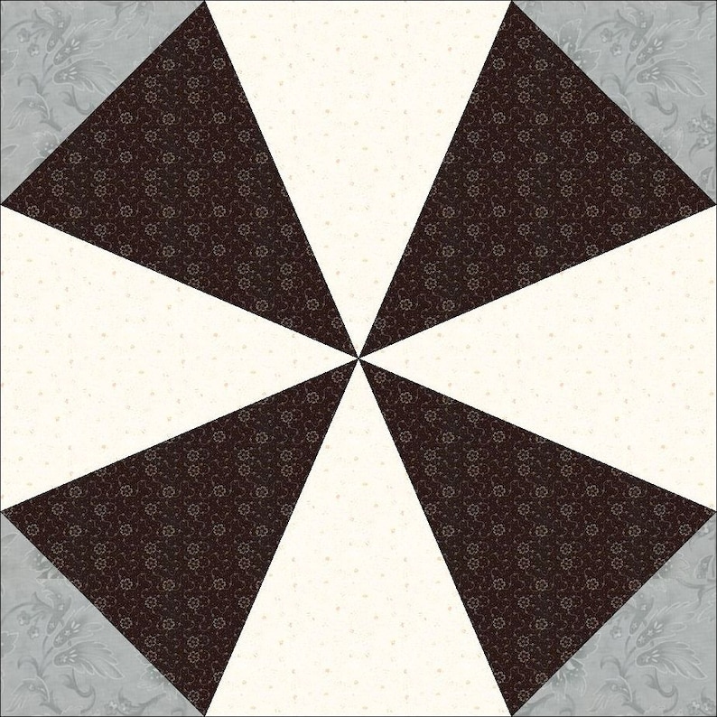 May include: A quilt block with a geometric design featuring four black triangles with a white floral pattern, four white triangles with a small black dot pattern, and four gray triangles with a floral pattern.