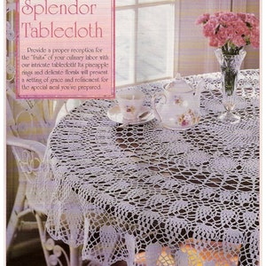 May include: White crocheted tablecloth with a pineapple design. The tablecloth is laid on a table with a teapot, cups, and a vase of pink carnations. The text "Carnation Splendor Tablecloth" is in a pink box at the top of the image.