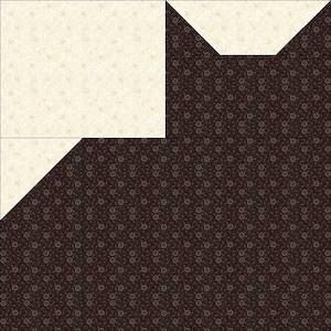 May include: A patchwork quilt block featuring a cream-colored fabric with a subtle floral pattern and a dark brown fabric with a repeating floral design. The block is composed of several geometric shapes.