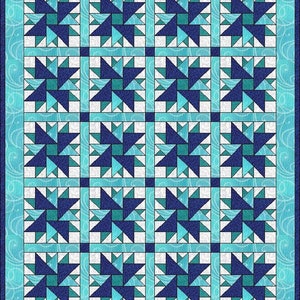 May include: A quilted textile featuring a repeating star pattern in shades of blue and teal. The stars are set against a white background and framed by a light blue border with a swirling design. The quilt is a square shape.