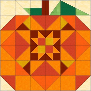 May include: A square quilt block pattern featuring a stylized pumpkin design. The pumpkin is constructed from geometric shapes in shades of orange, red, and brown, with a central star motif, a dark brown stem, and two green leaves on a cream background.