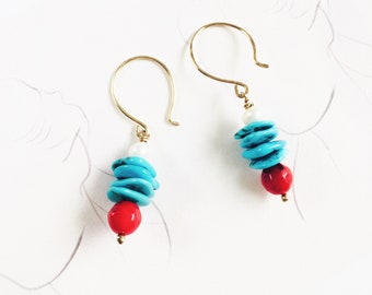 May include: Gold dangle earrings with turquoise and red beads. The turquoise beads are stacked in a pyramid shape and the red beads are round.