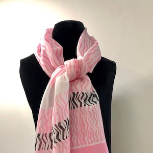 Made in Italy -  Pretty in pink with this sheer pink, white and black zig zag patterned scarf.