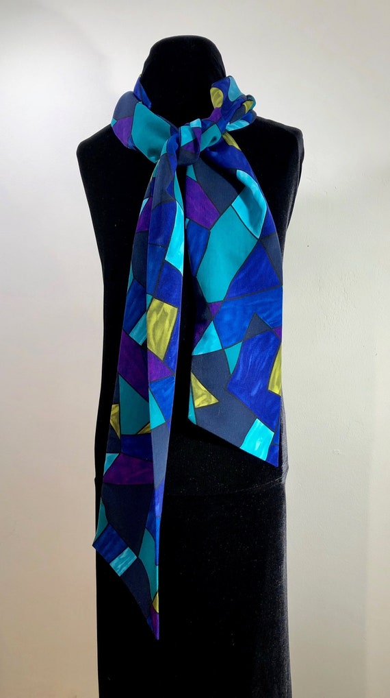 A smooth as silk "skinny" geometric scarf of rich 