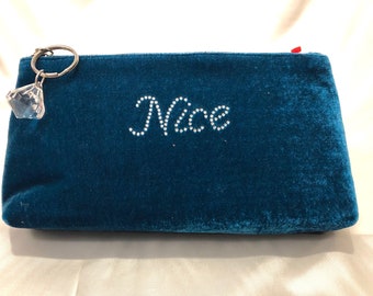 A turquoise blue soft velvet fun zippered clutch with tiny rhinestoned "naughty" and "nice" !