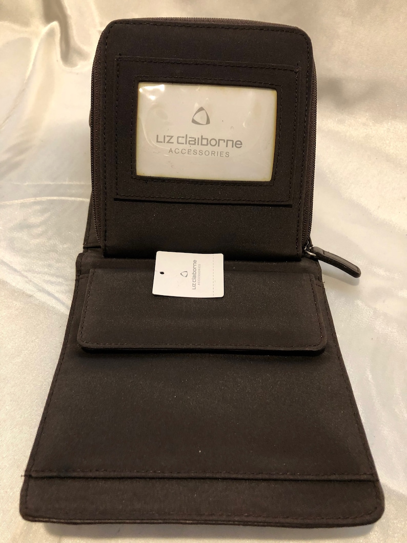 A soft buttery chocolate brown leatherette foldover clutchwallet with snap closure tucked beneath for a clean sleek look. Liz Claiborne