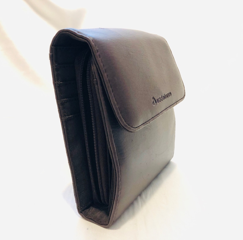 A soft buttery chocolate brown leatherette foldover clutchwallet with snap closure tucked beneath for a clean sleek look. Liz Claiborne