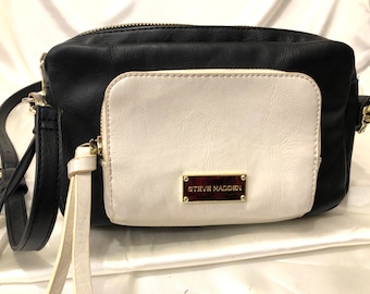 Steve Madden - A black and white leatherette cross body bag with a separate white purse attached to the front - totally stylish - convenient