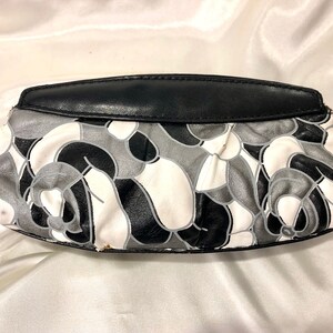 California Accessories - A small soft vinyl black, gray and white clutch with black vinyl trim. A handsome little piece for anywhere wear!
