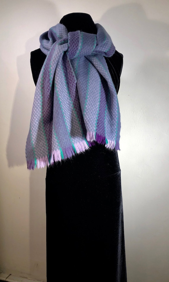 A purple, lilac and grey striped soft, warm scarf 
