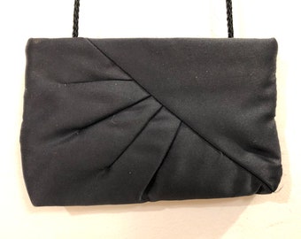 La Regale  -  A black soft silken clutch/crossbody bag with a thin black braided strap tucked inside - a sophisticated timeless classic