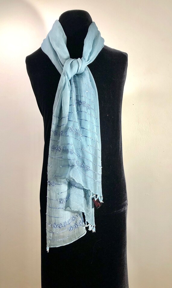 A diaphanous  dusty turquoise scarf in sky blue em
