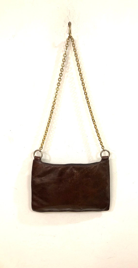AX Armani Exchange A reddish brown leatherette shoulder bag with a  brass chain strap touch of casual chic for the upbeat glamour gal!