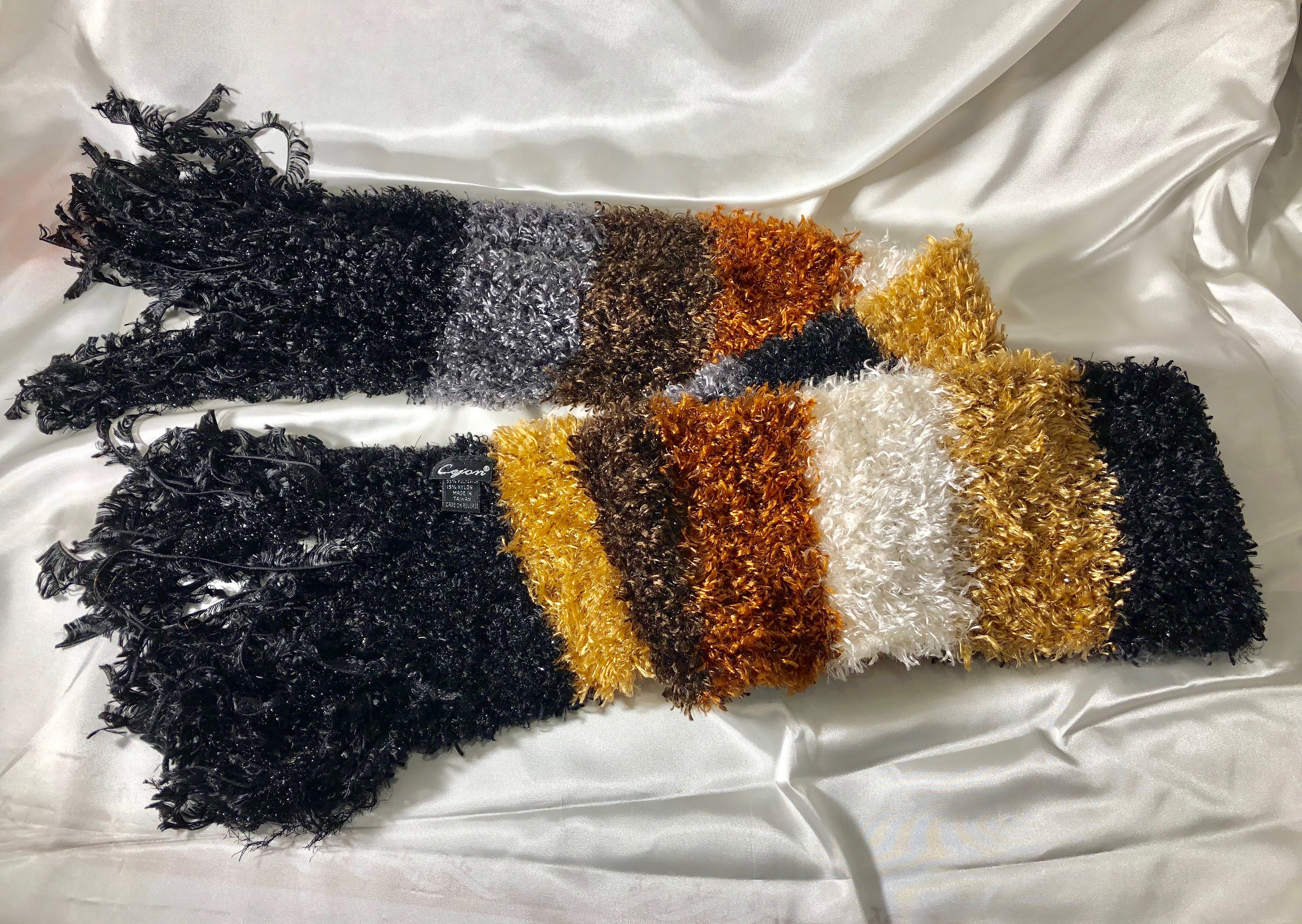 Cejon - A Looped Sparkly Knitted Scarf With Coppery, White