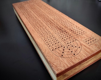 Cribbage Board 4 track.  Engraved Skunk lines.  Mahogany Surface with Ash Middle.  Storage for cards and pieces.  Original Design.