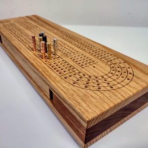 Oak 4-track Cribbage Board with On-Board Storage for Included Cards/Pegs.  Original Design Heirloom Board.  Precision Engraved Lines