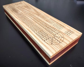 Cribbage Board 4 track.  Engraved Skunk lines.  Storage for cards and pieces.  Original Design. Ash Hardwood Surface with Mahogany Accent