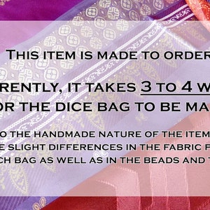 May include: A close-up of a purple and gold fabric with a white text overlay. The text reads: "This item is made to order. Currently, it takes 3 to 4 weeks for the dice bag to be made. Due to the handmade nature of the item, there can be slight differences in the fabric pattern of each bag as well as in the beads and tassels."