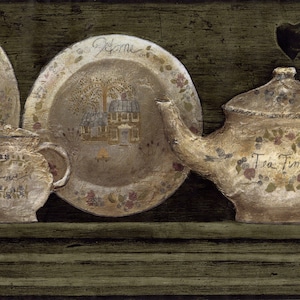 May include: A vintage-style tea set with a teapot, sugar bowl, and two plates. The teapot has a brown and white floral design with the words "Tea Time" on the side. The plates have a similar design with the words "Welcome" and "Love" on them. The set is displayed on a wooden shelf.