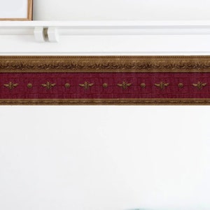 May include: A decorative wallpaper border with a burgundy background and gold accents. The border features a repeating pattern of bees and ornate designs.
