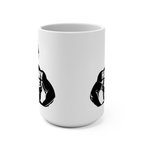 May include: White ceramic mug with a black silhouette of a muscular figure lifting weights. The text "Heavy Metal" is printed on the figure's chest.