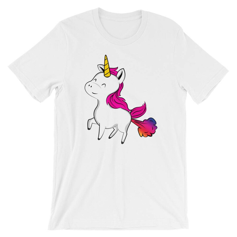May include: White t-shirt with a cartoon unicorn with a rainbow colored fart. The unicorn has a pink mane and a yellow horn.