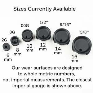 May include: A set of black rubber ear gauges in various sizes, ranging from 6 mm to 16 mm. The sizes are labeled in both metric and imperial measurements. The text reads "Sizes Currently Available".