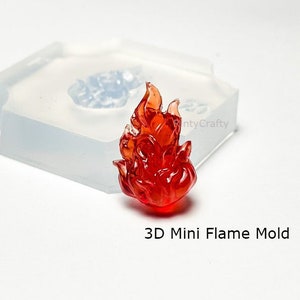 May include: A clear silicone mold for making a 3D mini flame. The mold is shown with a red flame made from resin.
