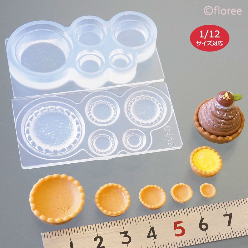 May include: A set of clear silicone moulds for making miniature tarts and pies. The moulds are in various sizes and shapes, with some having a decorative edge. The image also shows several miniature tarts made with the moulds, ranging in size from 1 to 5 inches in diameter.