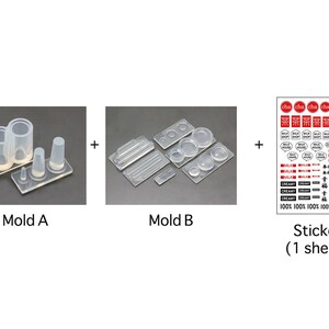 May include: Three clear silicone molds for making miniature food items, including a set of three cylinders, a set of four circles, and a set of three rectangular shapes. A sheet of stickers with various designs, including text in Japanese, is also included.