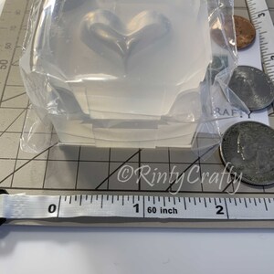May include: Clear silicone mold shaped like a heart, measuring approximately 1 inch in diameter. The mold is packaged in a clear plastic bag.