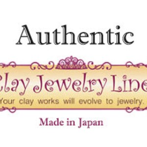 May include: A logo for Clay Jewelry Line, a company that makes jewelry from clay. The logo is on a yellow banner with a gold crown and scrollwork. The text "Authentic Clay Jewelry Line" is in black, and the text "Your clay works will evolve to jewelry." is in a smaller font. The text "Made in Japan" is at the bottom of the banner.