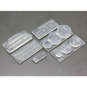 May include: A set of clear silicone molds for crafting. The molds feature various shapes, including circles, ovals, and a rectangular mold with lines.