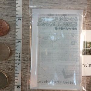 May include: A clear plastic packaging containing a white card with Japanese text that reads "Soft Mold Series Box Lid Mold with Attachment Ring Included." The card also has the text "Lovely Parts Series" at the bottom.