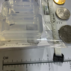 Puede incluir: Un molde de silicona transparente para hacer manualidades de resina. El molde tiene la forma de una peque&ntilde;a casa con una ventana y una puerta. El molde mide aproximadamente 2,5 cm de ancho y 3,8 cm de alto.