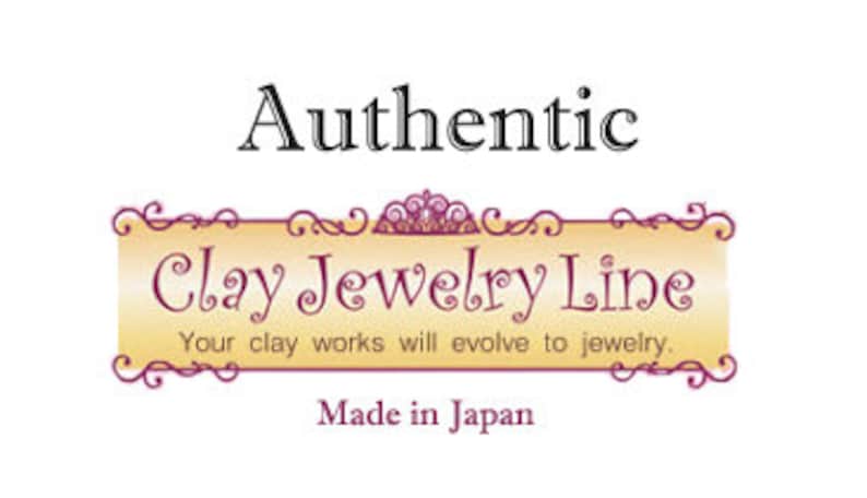 May include: A logo for Clay Jewelry Line, a company that makes jewellery from clay. The logo is on a yellow banner with a gold crown and scrollwork. The text "Authentic Clay Jewelry Line" is in black, and the text "Your clay works will evolve to jewellery." is in a smaller font. The text "Made in Japan" is at the bottom of the banner.