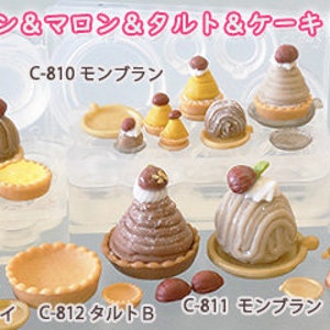 May include: Assortment of silicone cake moulds for baking various desserts, including a bundt cake, a tart, a mont blanc, and a round cake. The moulds are labelled with Japanese text and the words "New Mold".