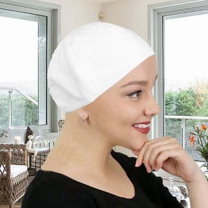 May include: A white cotton beret style chemo hat for women with cancer. The hat is soft and comfortable, and it can be worn in a variety of ways.